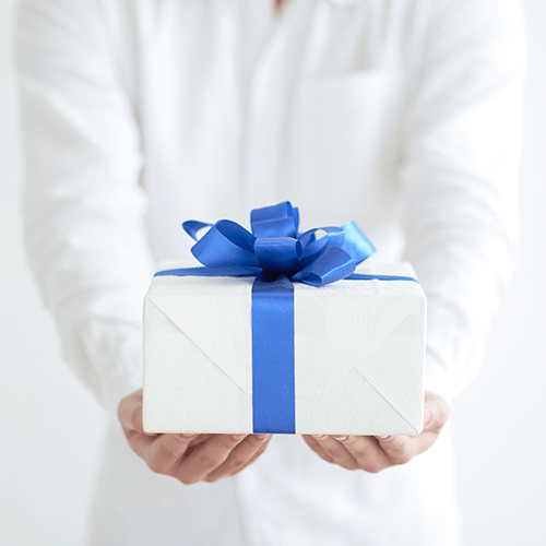 Employee holding a gift box with a blue ribbon