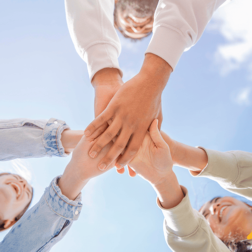 Team members stacking their hands together